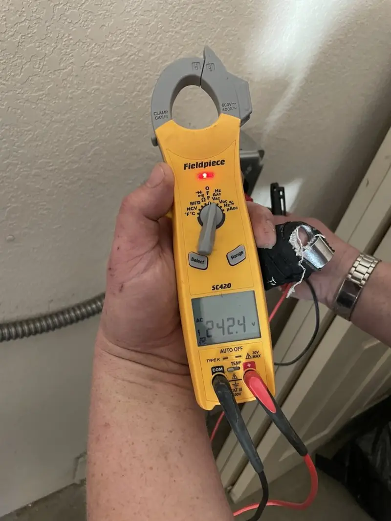 Voltage testing with clamp meter during Electrical Installation Services in Harriman